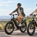 Muškarac i žena voze električne bicikle s kacigama na cesti iznad grada